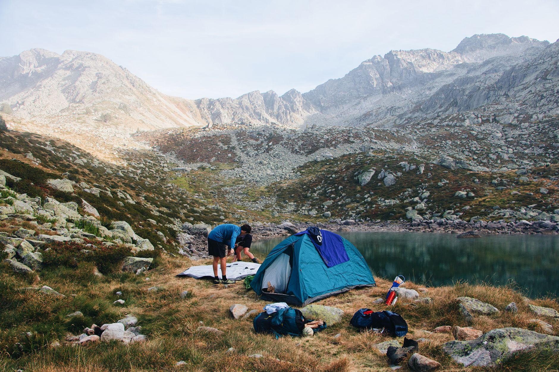 Camping by a serene lake in Barèges, France, surrounded by majestic mountains.