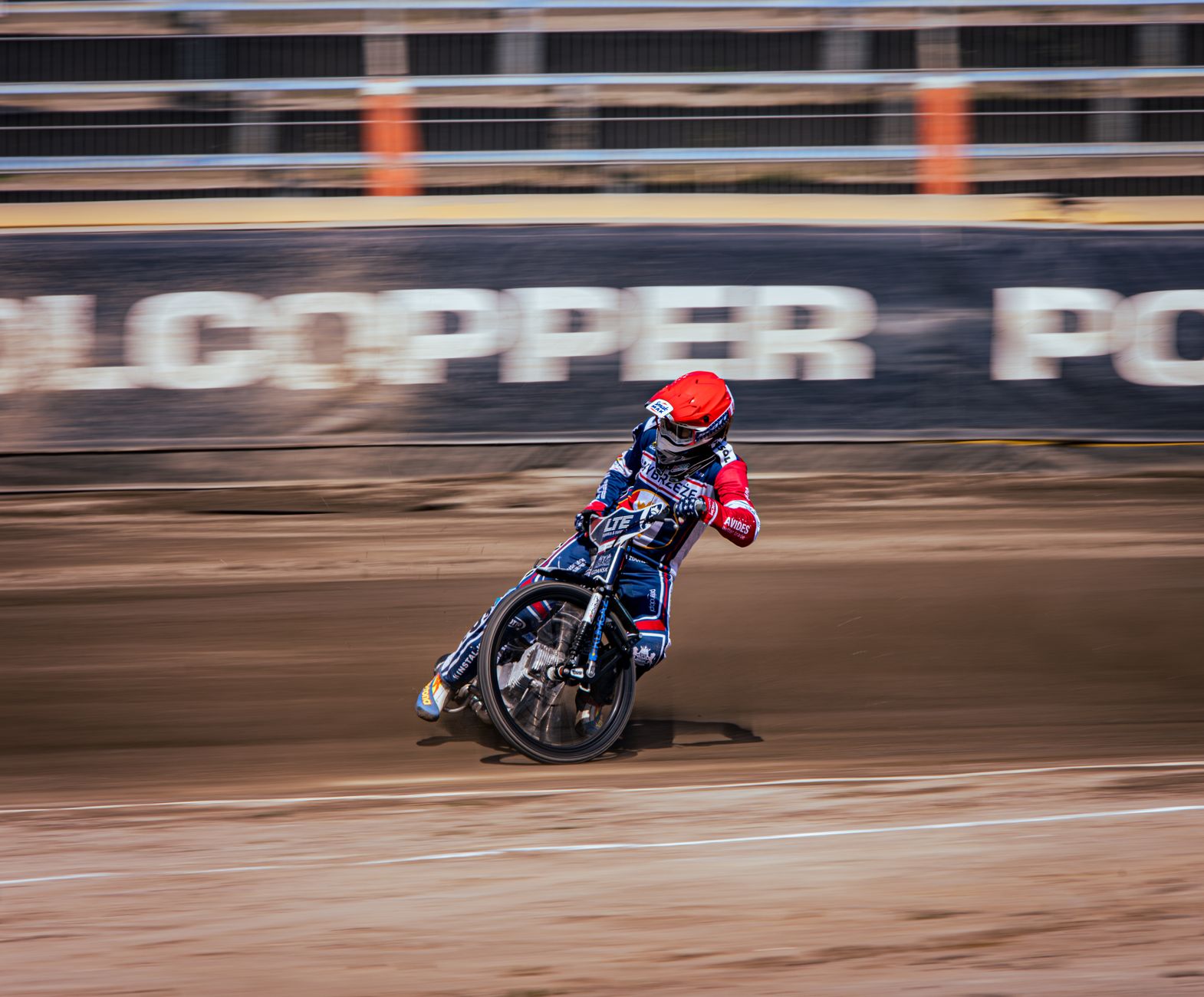 Exciting motorcycle racing scene capturing a motorcyclist speed on a dirt track.
