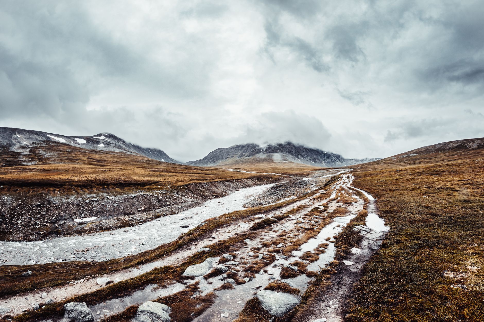 Explore the rugged beauty of Trollheimen's mountainous wilderness under dramatic skies.