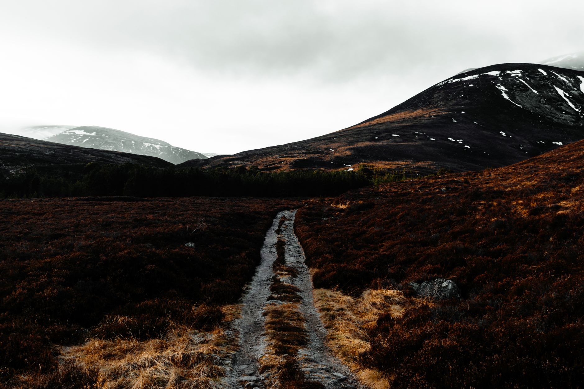 Explore the rugged terrain of the Scottish Highlands with a winding path through dramatic landscapes.