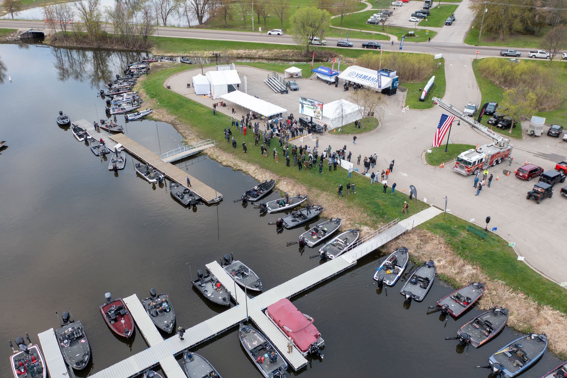 A vibrant scene of boat docks and people gathered along the Mississippi River in Wabasha.