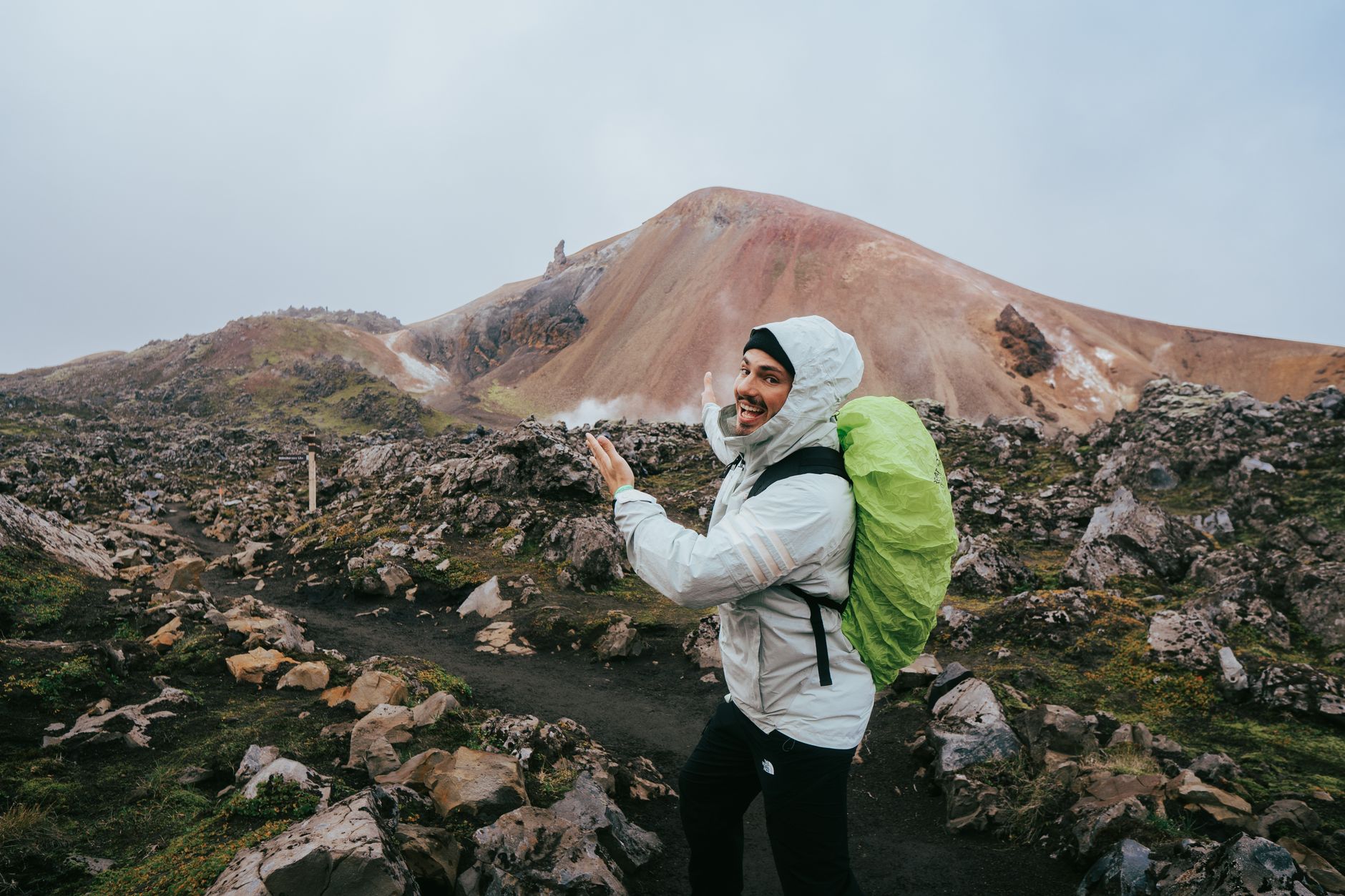 Hiker enjoying scenic views in Landmannalaugar, Iceland. Ideal for travel and outdoor adventure themes.